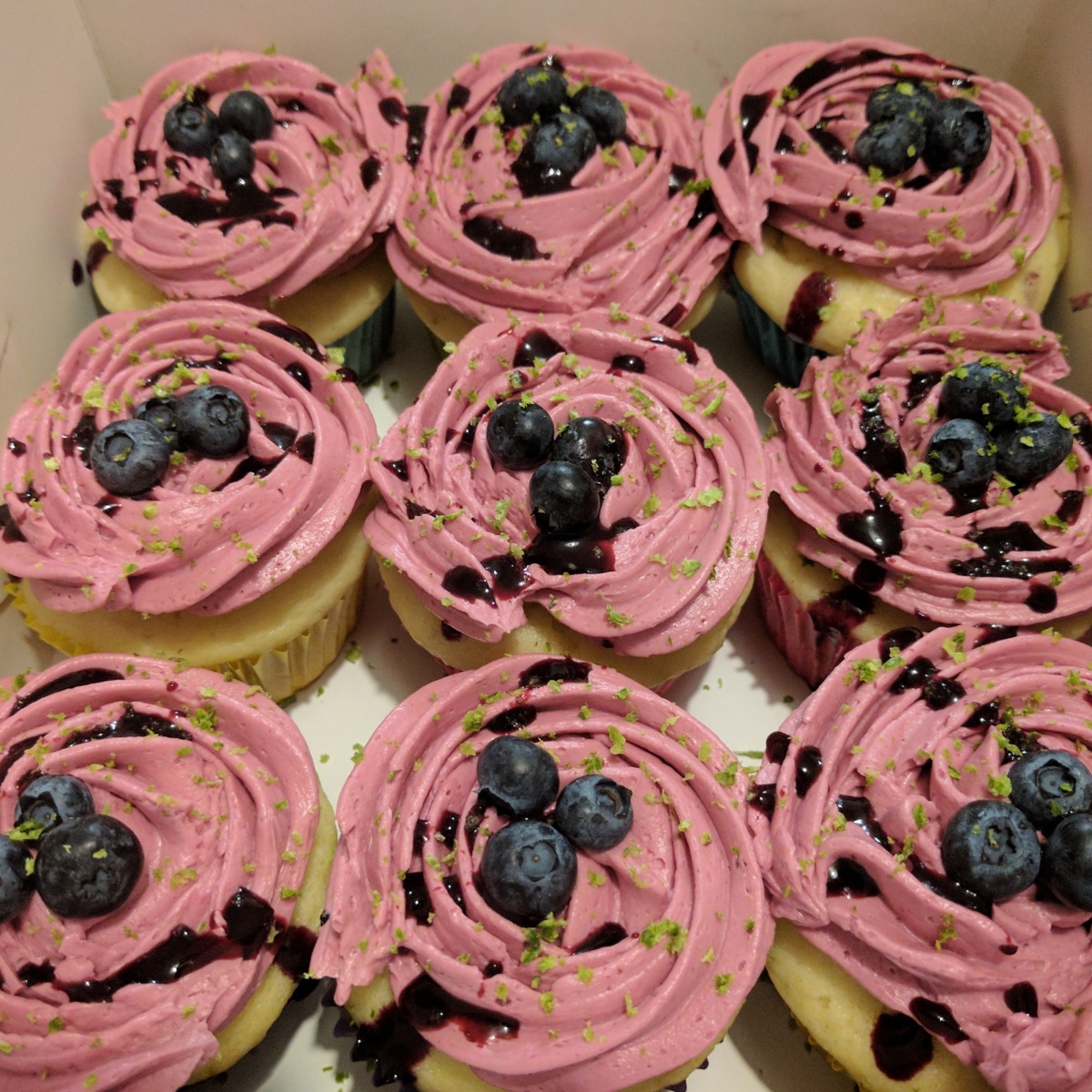 Can't stop eating these- Lemon cupcakes with blueberry buttercream frosting.